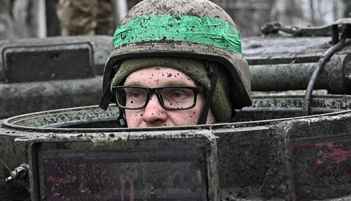 A soldier looks out of the hatch of an armoured personnel carrier (APC) in the town of Chasiv Yar, Donetsk region on April 3, 2023.—AFP/file