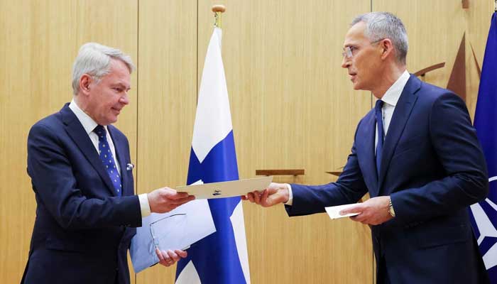 Nato Secretary-General Jens Stoltenberg (R) hands over Finlands accesssion to Nato documents to Finnish Foreign Affairs Minister Pekka Haavisto. — AFP/File