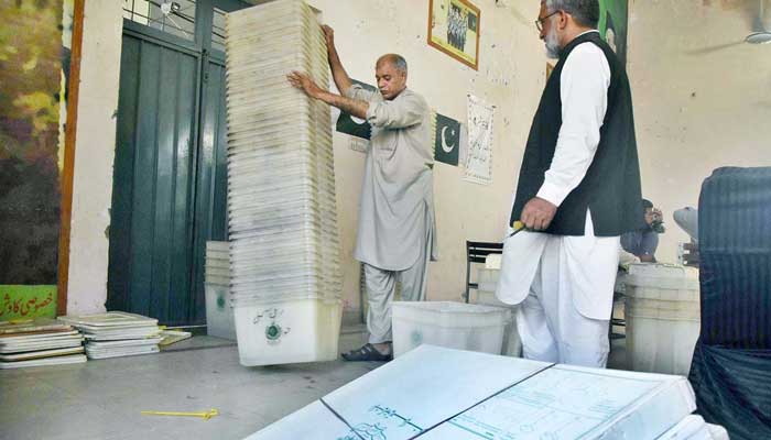 Election Commission of Pakistans (ECP) appointed polling staff collect ballot boxes and other items from polling stations during local body elections in Lahore on July 16, 2022. — APP