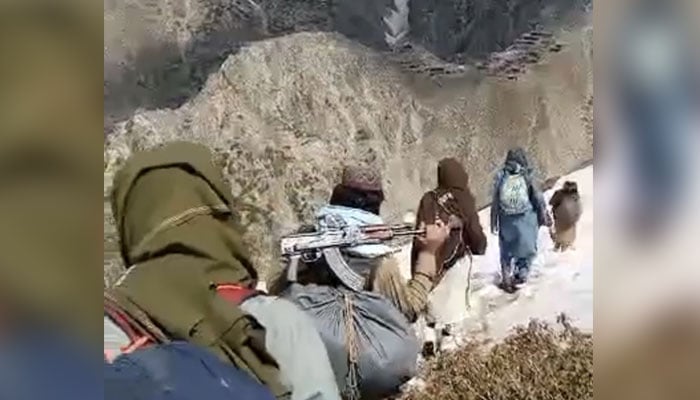 In an undated photograph, a group of armed men is heading on its way in a mountainous region. — Twitter/@SaleemMehsud