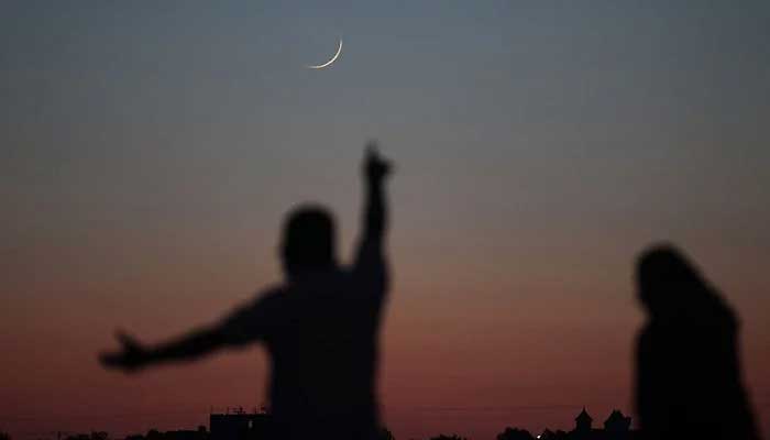 A man reacting after spotting the crescent on the sky. — AFP/File