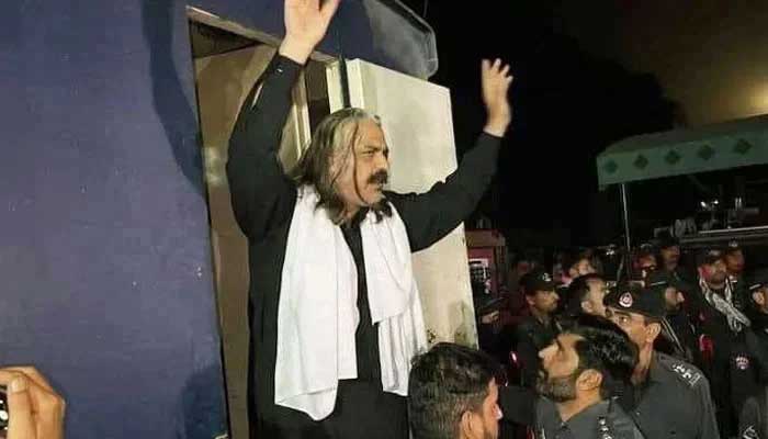 PTI leader Ali Amin Gandapur waves at crowd after police take his custody in Dera Ismail Khan on March 6, 2023. — Twitter/@Jhagra