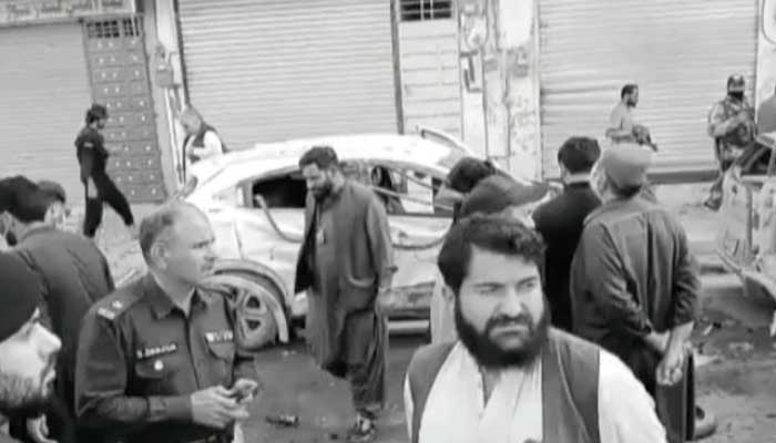 People and police officials stand at site where blast went off in Quetta on April 10, 2023, in this still taken from a video. — YouTube/Geo News