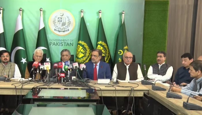 Law Minister Azam Nazeer Tarar (C) addresses a press conference along with Adviser to PM Qamar Zaman Kaira (R) and other leaders of the coalition parties in Islamabad, on April 13, 2023, in this still taken from a video. — YouTube/PTVNews