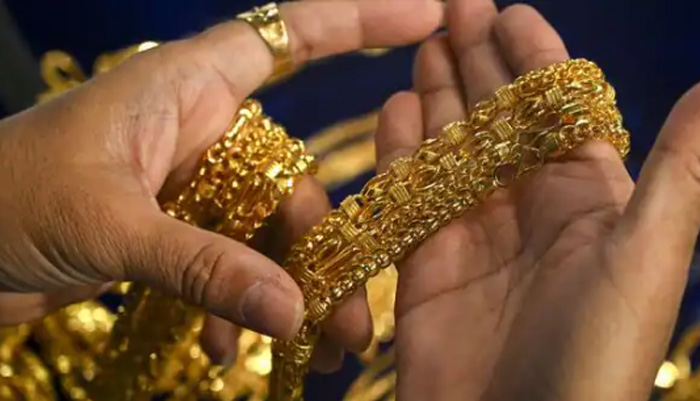 A jeweller displays gold chains at his shop in India. — AFP/File