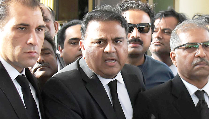 PTI leader Fawad Chaudhry speaks to media persons outside the Supreme Court in Islamabad on March 28, 2023. — INP
