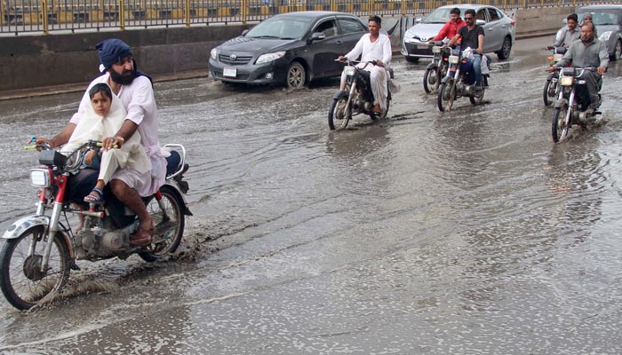 Motorists are facing difficulties due to accumulated rain water at North Nazimabad road in Karachi on March 23, 2023. — Online