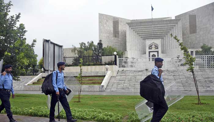 Police personals walk outside the Supreme Court in Islamabad on July 25, 2022. — AFP