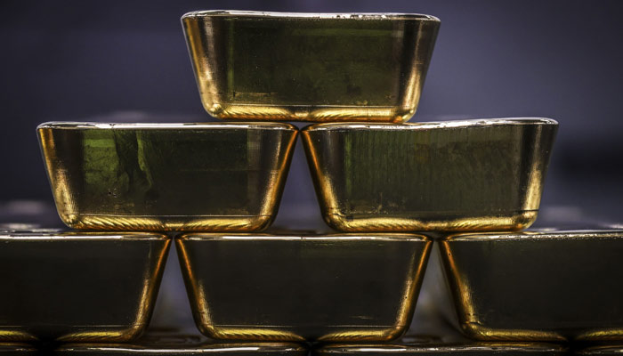 Gold bullion bars are pictured after being inspected and polished at the ABC Refinery in Sydney on August 5, 2020. — AFP