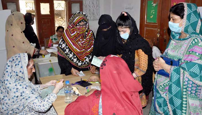 Women cast votes at a polling station in Hyderabads Latifabad area during the local bodies by-polls held on Sunday, May 7, 2023. — PPI