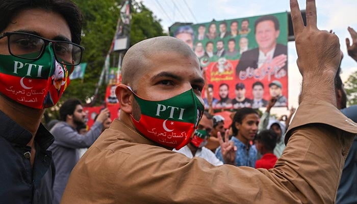 PTI activists and supporters of former prime minister Imran Khan celebrate after Supreme Court declared Khans arrest invalid, in Lahore on May 11, 2023. — AFP