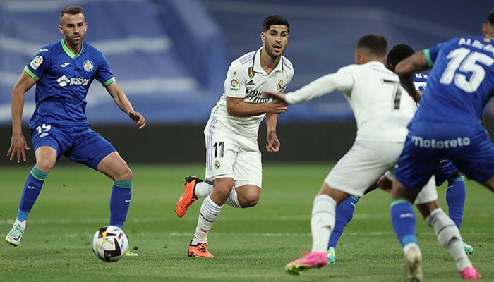 Real Madrid´s Spanish midfielder Marco Asensio vies with Getafe´s Spanish forward Borja Mayoral (L) during the Spanish league football match between Real Madrid CF and Getafe CF at the Santiago Bernabeu stadium in Madrid on May 13, 2023. AFP