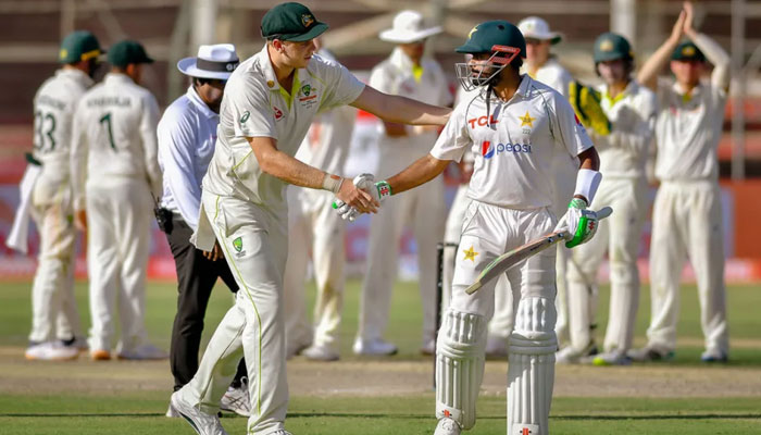 Australias Cameron Green congratulates Pakistan skipper Babar Azam after his 196. — AFP/File
