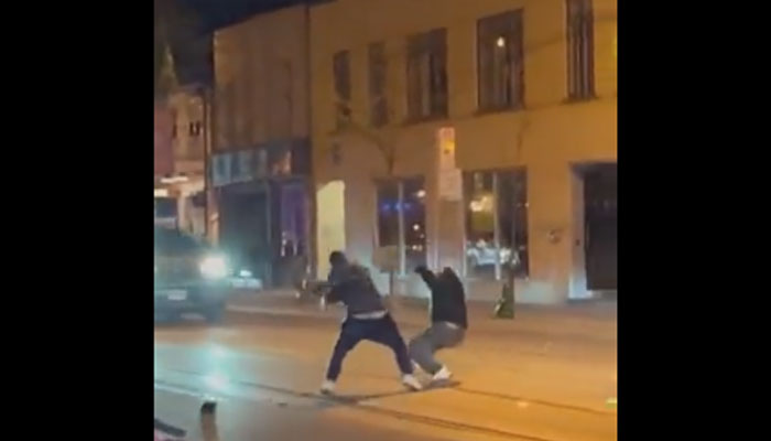 A man strikes the rival with his pet python on a street in Canada. — Twitter/ @crazyclipsonly