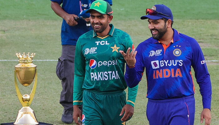 Pakistani cricket team captain Babar Azam (left) and Indian captain Rohit Sharma while speaking during a match day. — AFP/File