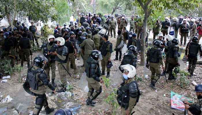 A heavy police contingent present in Lahores Zaman Park area to conduct a search and cleanup operation at the residence of PTI Chairman Imran Khan on Saturday, March 18, 2023. — PPI