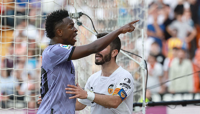 Real Madrid´s Brazilian forward Vinicius Junior reacts to being insulted pointing at the stands during the Spanish league football match between Valencia CF and Real Madrid CF at the Mestalla stadium in Valencia on May 21, 2023.