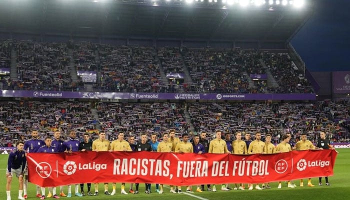 Players from Barcelona and Real Valladolid held an anti-racism message before the game. AFP