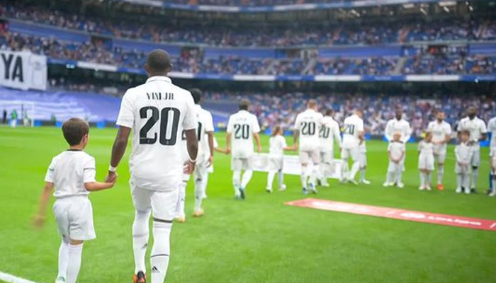 Real Madrid players walk out wearing Vinícius Jr.s No. 20 shirt. Twitter/ESPNFC