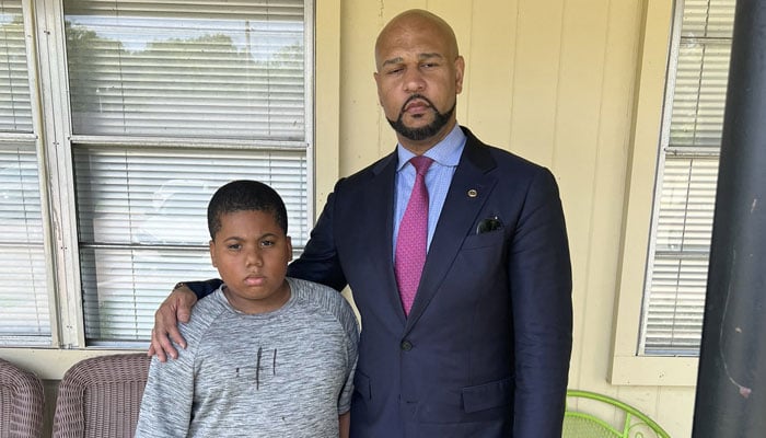This undated image courtesy of attorney Carlos Moore shows Aderrien Murry, 11, with family attorney Carlos Moore, after Murry was shot May 20, 2023, in Indianola, Mississippi. — AFP