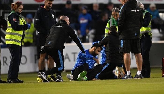 Medical staff giving Shadab Khan first aid after his collision with Nathan McAndrew amid match between Sussex and Somerset on May 26, 2023. — AFP