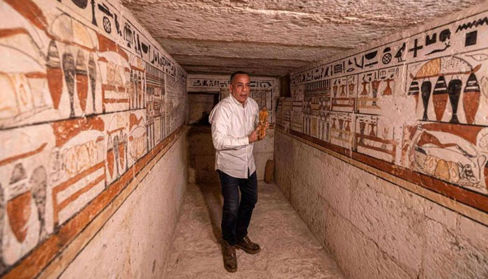 Mostafa Waziri, the head of Egypts Supreme Council of Antiquities, walks inside one of the five ancient Pharaonic tombs recently discovered at the Saqqara archaeological site, south of the capital Cairo. — AFP/File