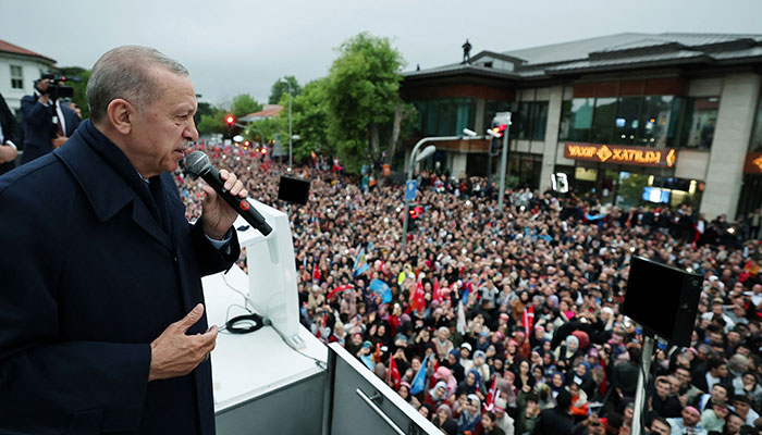 This handout photograph taken and released by the Turkish Presidency Press Office on May 28, 2023 shows Turkish President Recep Tayyip Erdogan addressing supporters gathered outside his residence following his victory in Turkish presidential election at Kisikli district in Istanbul. AFP