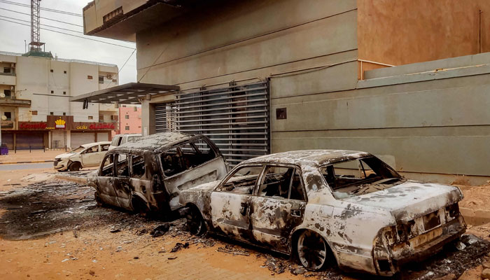 Destroyed vehicles are pictured outside the burnt-down headquarters of Sudan´s Central Bureau of Statistics, on al-Sittin (sixty) road in the south of Khartoum on May 29, 2023. — AFP