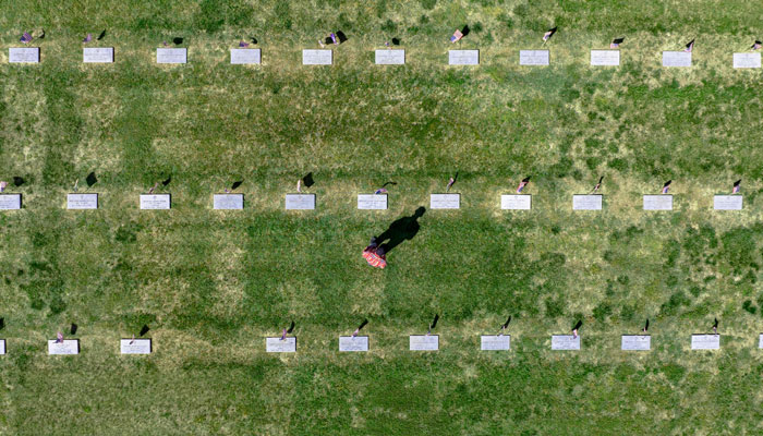 In this aerial view, a man visits the Eastern Shore Veterans Cemetery in Hurlock, Maryland, on May 27, 2023, ahead of the Memorial Day holiday. — AFP