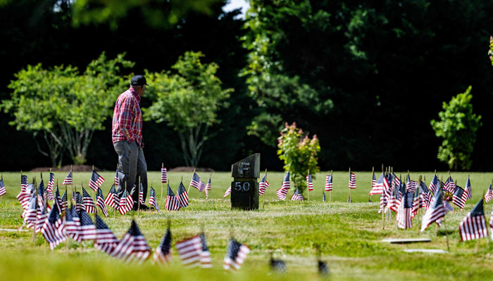 A man visits the Eastern Shore Veterans Cemetery in Hurlock, Maryland, on May 27, 2023, ahead of the Memorial Day holiday. — AFP