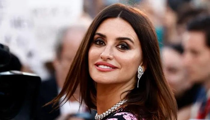 Penelope Cruz turns heads on the streets of Madrid as she shoots a commercial at a flower stall