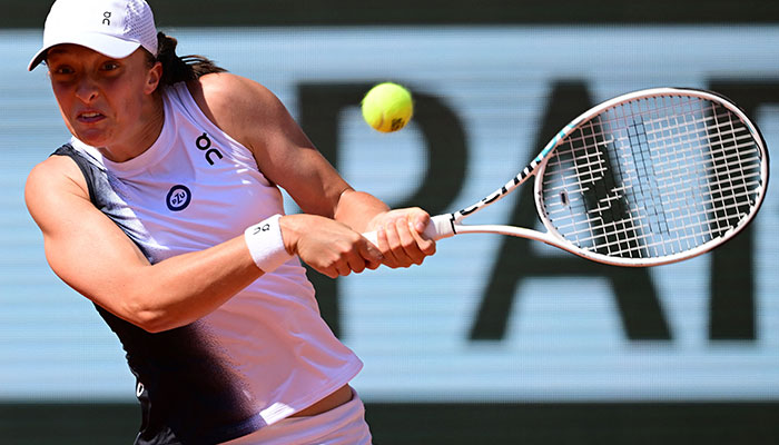 Polands Iga Swiatek plays a backhand return to US Claire Liu during their womens singles match on day five of the Roland-Garros Open tennis tournament at the Court Philippe-Chatrier in Paris on June 1, 2023. AFP