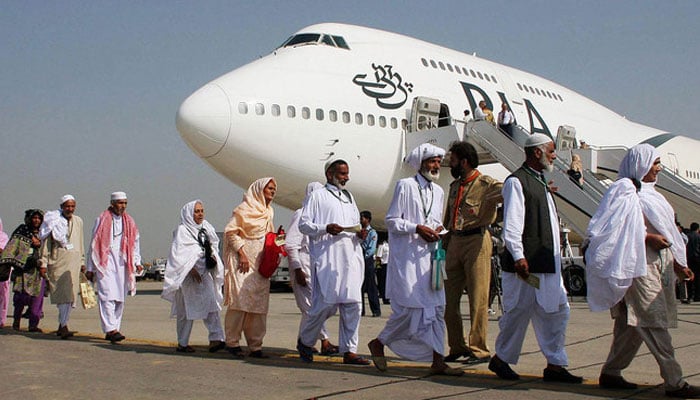 Pilgrims walk in line as they prepare to board a Pakistan International Airlines special Hajj pilgrimage flight bound for Saudi Arabia at the Allama Iqbal International airport in Lahore on November 2, 2008. — AFP