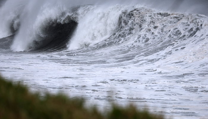 Violent waves of the sea are seen gushing over the coast. — AFP/File