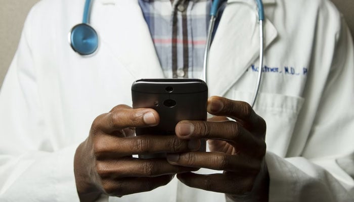 This representational picture shows a doctor using a smartphone. — Unsplash/File