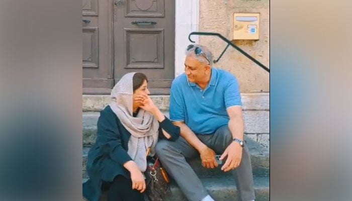 Former army chief General (retd) Qamar Javed Bajwa (right) and his wife can be seen interacting in this still taken from a video. — Twitter