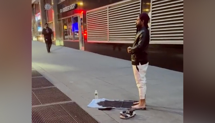 Pakistan wicketkeeper-batter Mohammad Rizwan prays on a streetside in New York, in this still taken from a video. — Twitter/@_FaridKhan