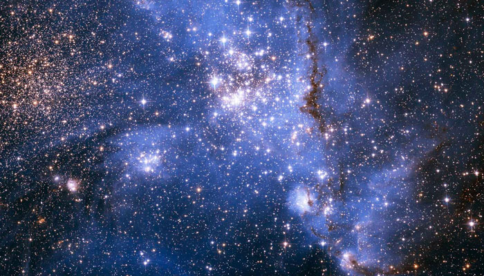 This image captured by the Hubble Telescope shows young stars spiralling into the centre of a massive cluster of stars in the Small Magellanic Cloud, a satellite galaxy of the Milky Way. — AFP/File