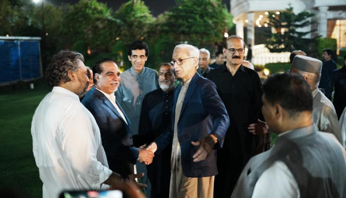 Jahangir Tareen (centre) greets ex-PTI members at Aleem Khans residence in Lahore on June 7, 2023. Twitter/@SHABAZGIL