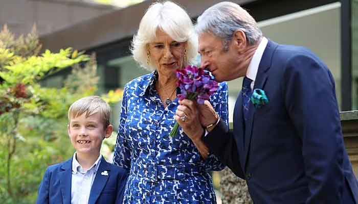 Camilla receives kiss on cheek from Kings friend as she opens British Flowers Week
