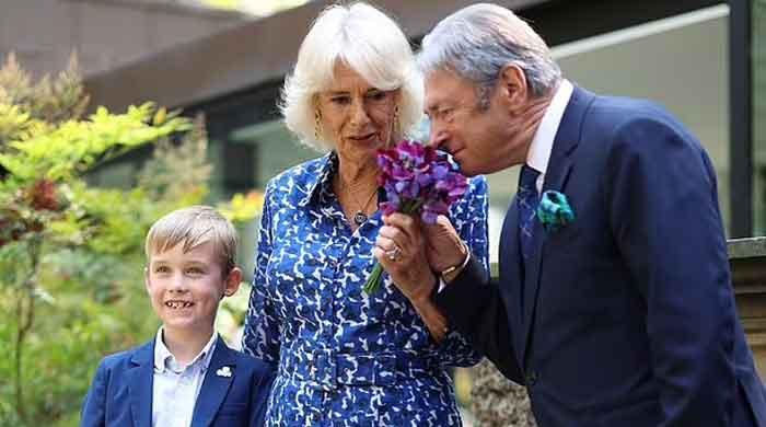 Camilla receives kiss on cheek from King's friend as she opens British Flowers Week