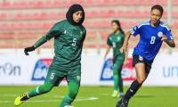 What does footballer Amina Hanif feel about playing in hijab?