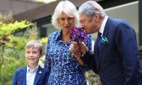 Camilla receives kiss on cheek from King's friend as she opens British Flowers Week