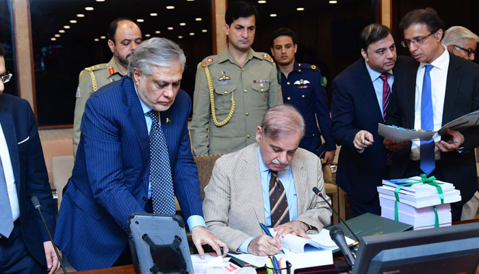 Prime Minister Shehbaz Sharif signs federal budget document for fiscal year 2023-24 on June 9, 2023. — PM Office 