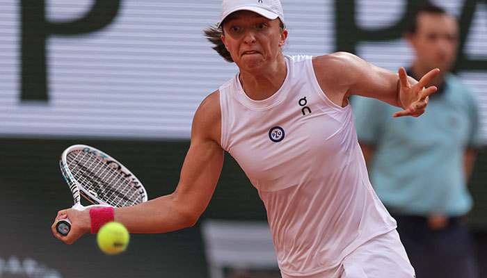 Polands Iga Swiatek plays a forehand return to Brazils Beatriz Haddad Maia during their womens singles semi-final match on day twelve of the Roland-Garros Open tennis tournament at the Court Philippe-Chatrier in Paris on June 8, 2023. AFP