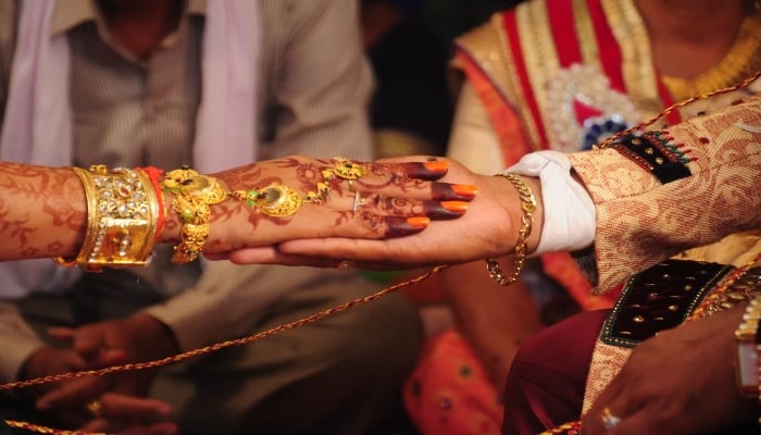 This representational picture shows an a bride and groom performing a ritual in an Indian wedding. — Unsplash/File