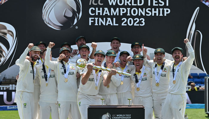 Australia´s Pat Cummins (Centre) lifts the ICC Test Championship Mace as he celebrates with teammates after victory in the ICC World Test Championship cricket final match between Australia and India at The Oval, in London, on June 11, 2023. — AFP