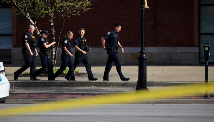 This representational picture shows a group of police officers walking past the crime scene. — AFP/File