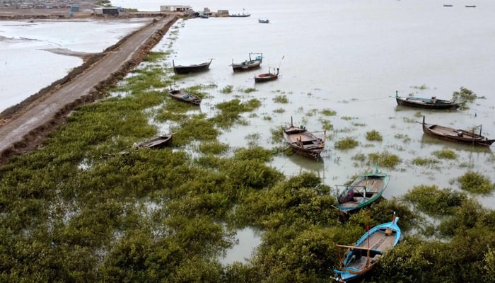 A general view of empty boats and houses at Keti Bandar on June 13, 2023. — AFP