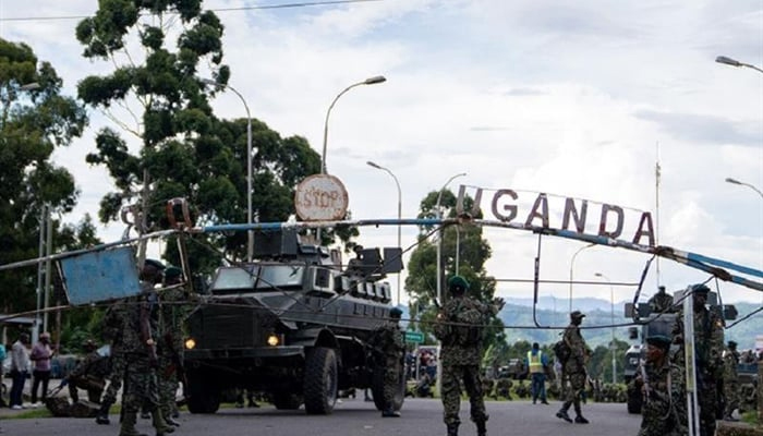 Members of the Uganda Peoples Defence Forces (UPDF) position themselves on the Ugandan side of the border town in Bunagana, Democratic Republic of Congo, while awaiting deployment on March 30, 2023. — AFP